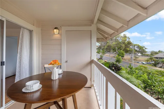 a view of a balcony dining table and chairs