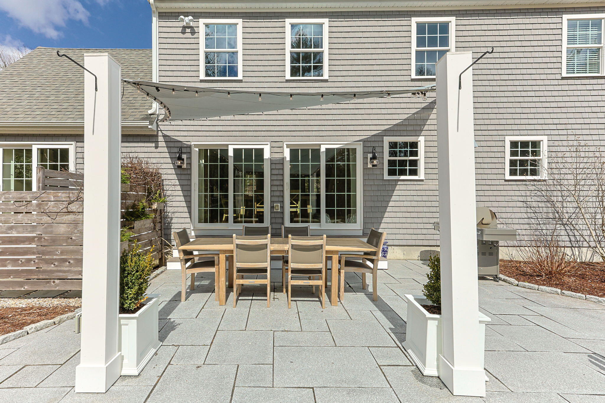 174 Cross Neck Road Marion, MA 02738 - Photo 36 of 41 a view of a patio with table and chairs and potted plants