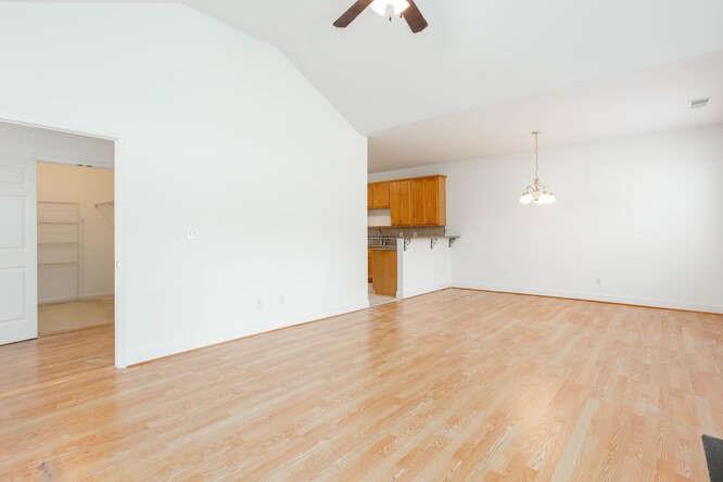 3402 Raes Creek Road, Unit 27 Marietta, GA 30008 - Photo 6 of 32 an empty room with wooden floor and windows
