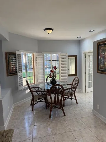 a dining room with furniture and window