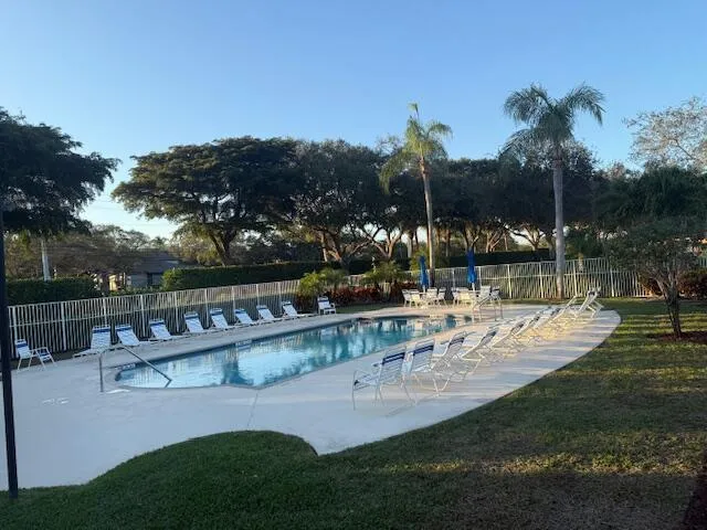 a view of backyard with swimming pool and outdoor seating