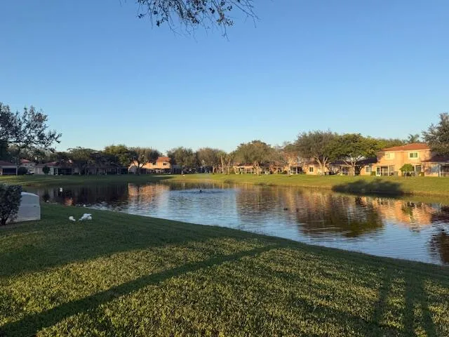 a view of a lake with houses in the back