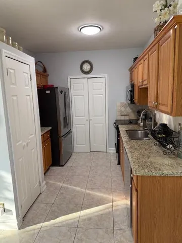 a kitchen with stainless steel appliances granite countertop a refrigerator and a stove