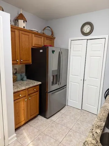 a kitchen with stainless steel appliances granite countertop a refrigerator and a stove