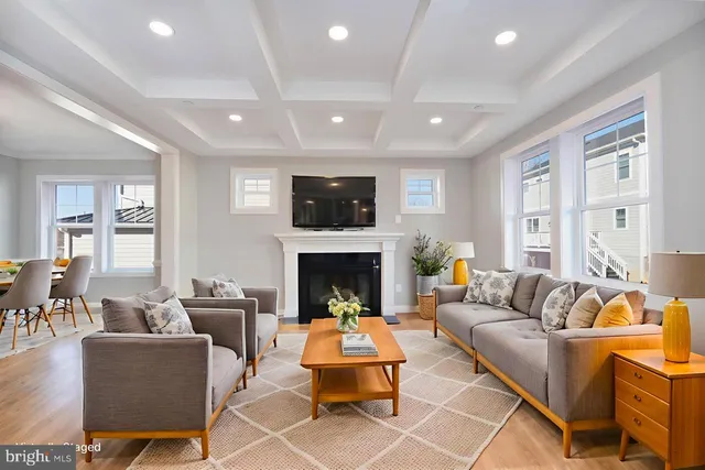 a living room with furniture fireplace and a large window