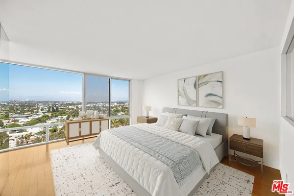 a bedroom with a large bed and a couch