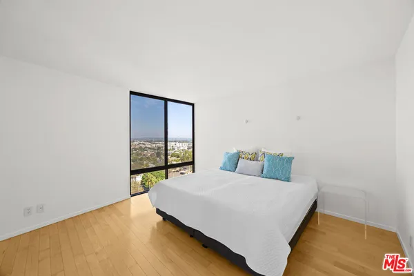 a bedroom with a bed and a table