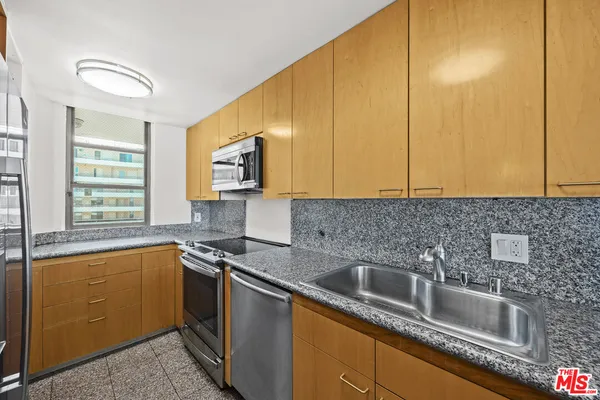 a kitchen that has a sink and a microwave