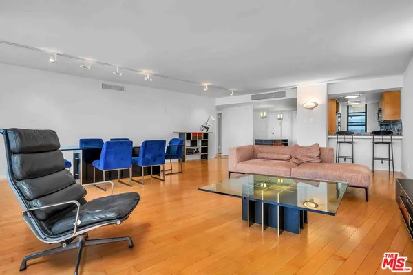 a living room with furniture a dining table and chairs