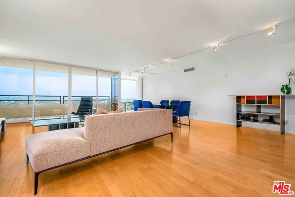 a living room with furniture and a pool table