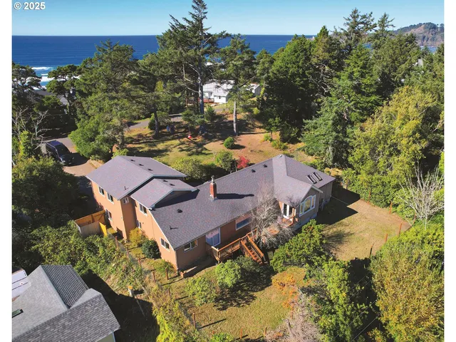 an aerial view of a house with yard swimming pool and outdoor seating