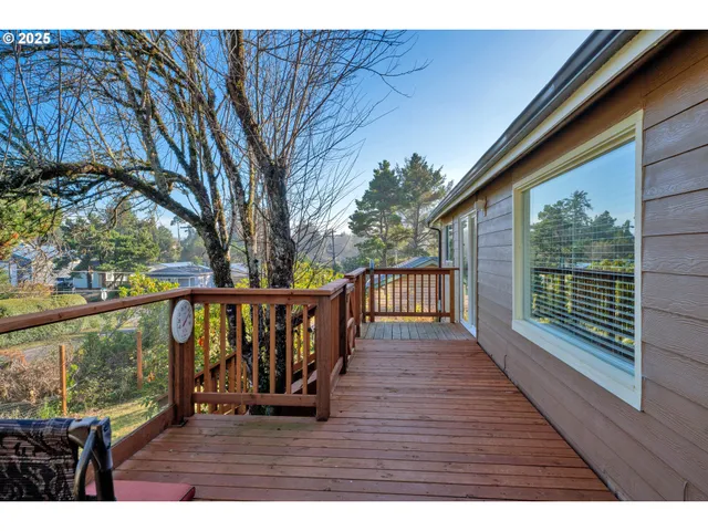 a balcony with wooden floor and outdoor seating