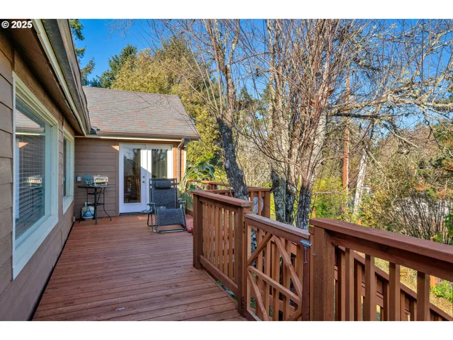a view of a house with a small yard and wooden fence