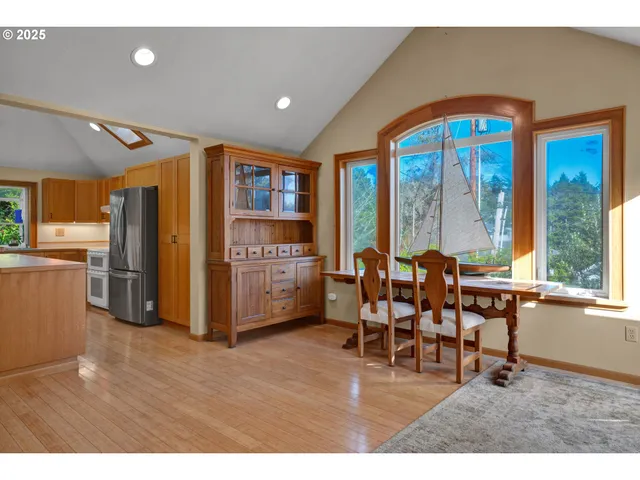 a view of a livingroom with furniture hardwood floor and a large window