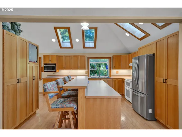 a living room with stainless steel appliances kitchen island granite countertop furniture and a kitchen view