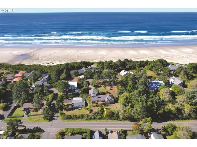a aerial view of a house next to a yard