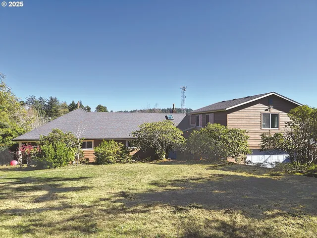 a backyard of a house with garage and outdoor seating