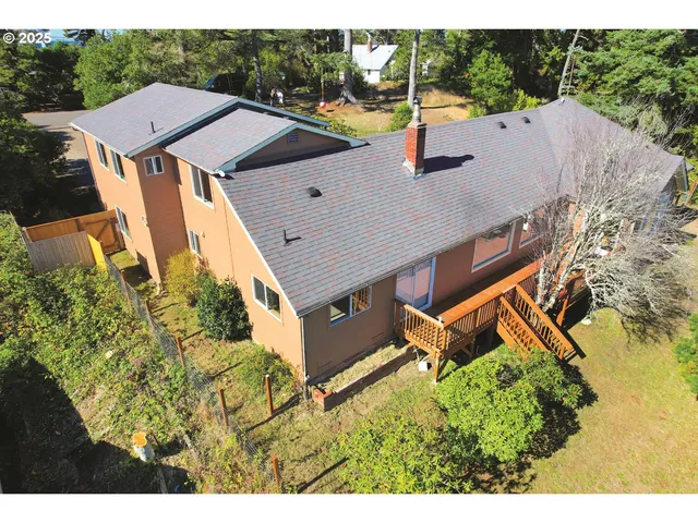 a aerial view of a house with a yard and sitting area