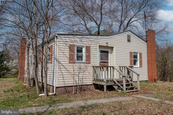 a view of a house with a yard and wooden fence