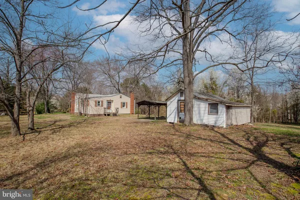 a front view of house with yard and trees
