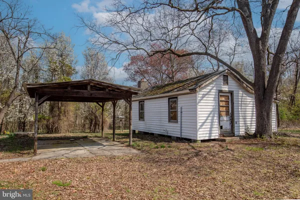 a view of a house with a yard and wooden fence