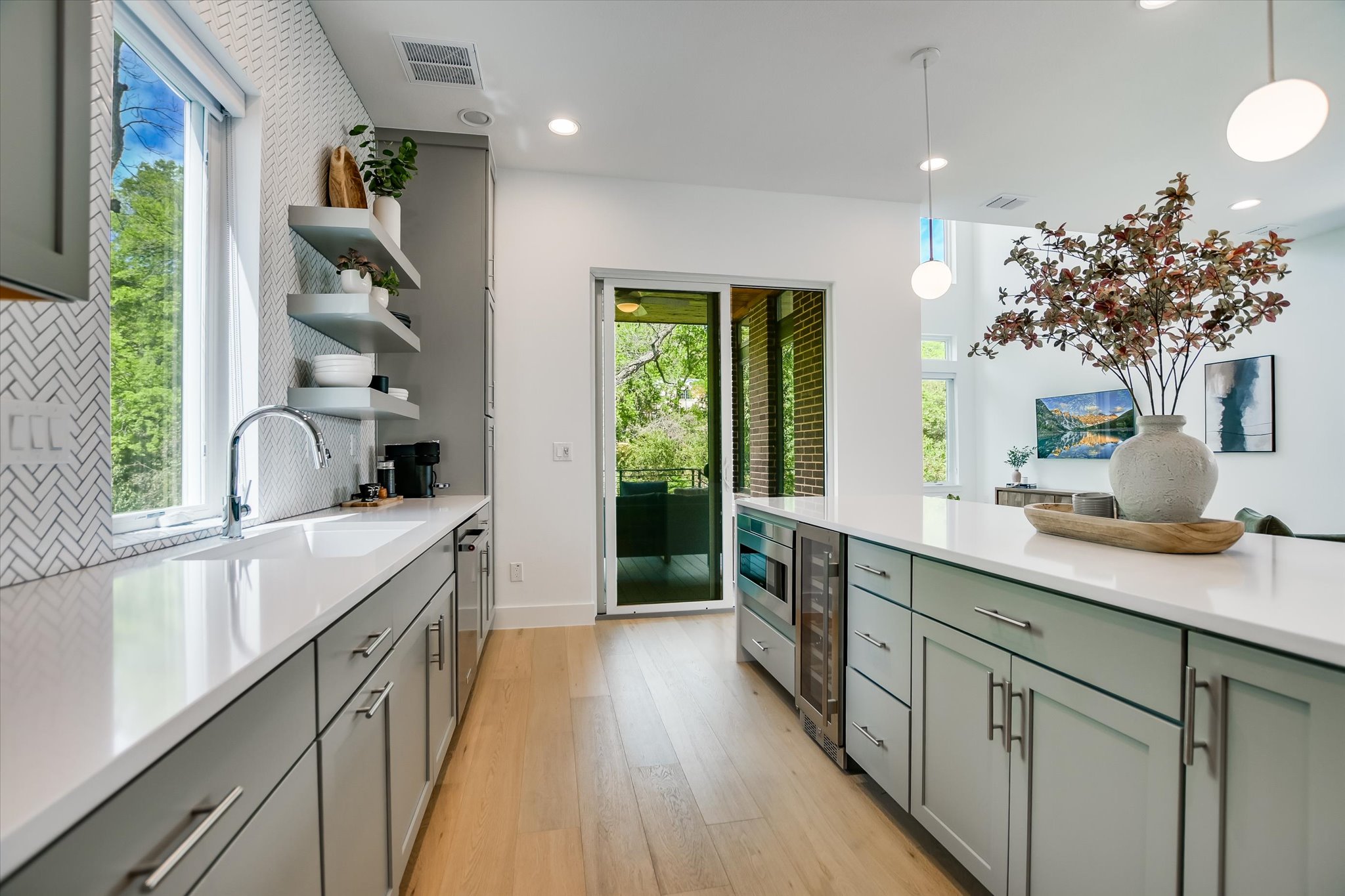 900 South 2nd Street, Unit 6 Austin, TX 78704 - Photo 12 of 25 a kitchen with kitchen island granite countertop a sink appliances cabinets and a large window