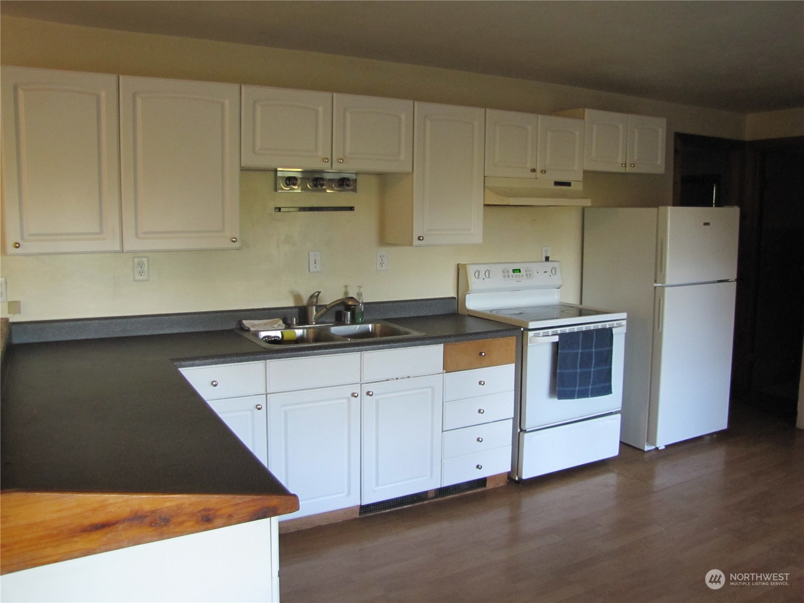 252 Lavender Ridge Lane Sequim, WA 98382 - Photo 6 of 28 a kitchen with stainless steel appliances granite countertop white cabinets and a refrigerator