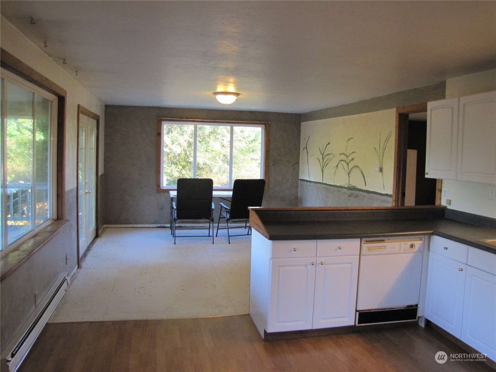 252 Lavender Ridge Lane Sequim, WA 98382 - Photo 7 of 28 a kitchen with granite countertop a stove and white cabinets