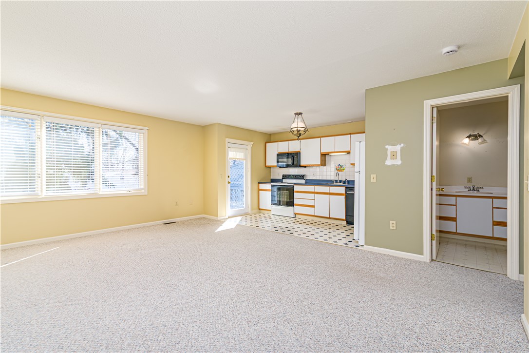 60 Margin Street, Unit 104 Westerly, RI 02891 - Photo 10 of 40 kitchen is in the back of the condo with access to the back deck