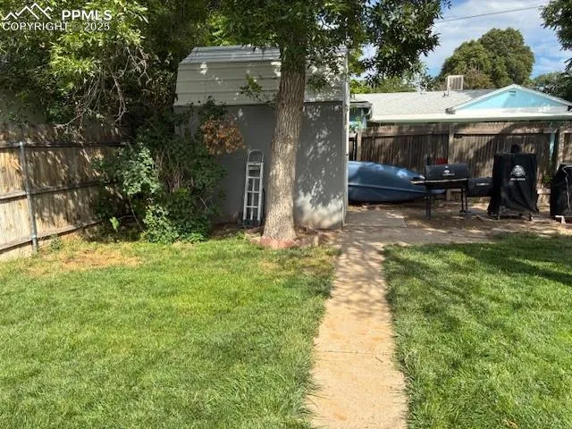 a backyard of a house with yard and outdoor seating