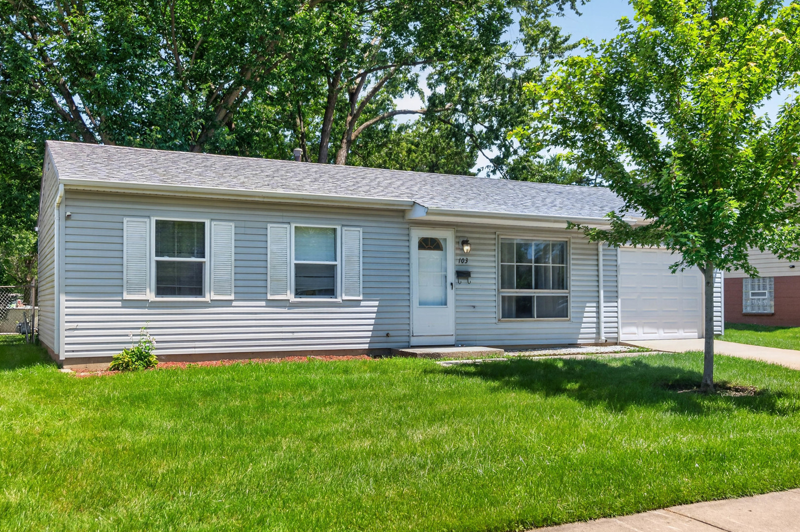 103 Willow Road Streamwood, IL 60107 - Photo 2 of 17 a front view of house with a garden