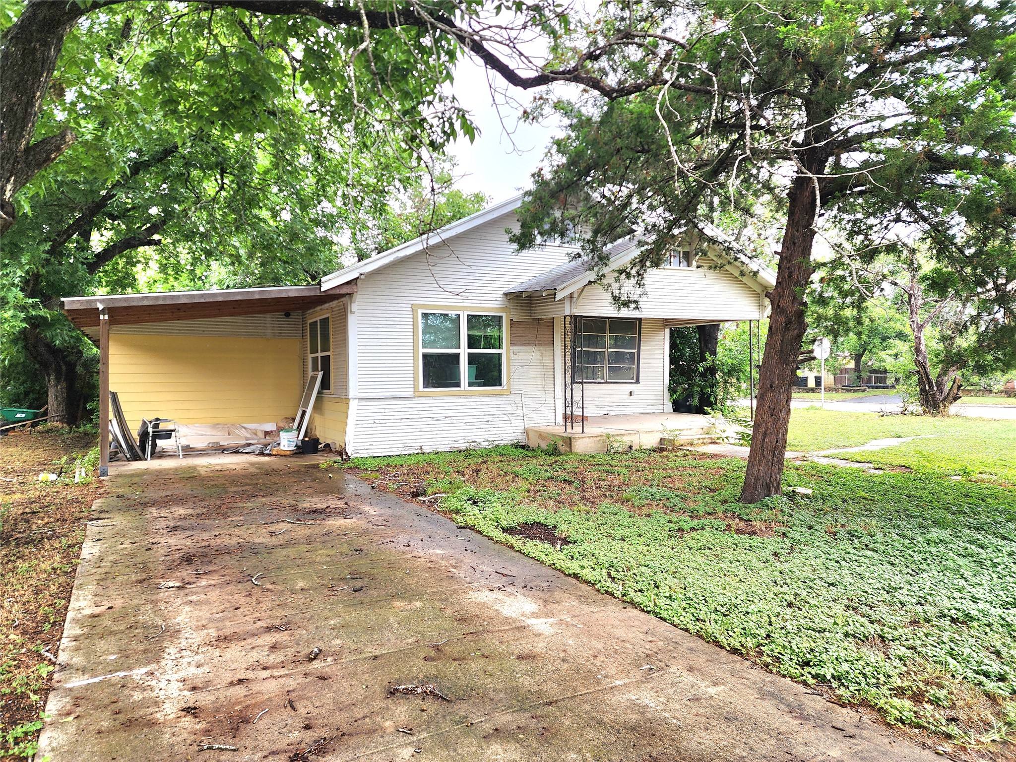 123 East Davis Street Luling, TX 78648 - Photo 3 of 14 A classic facade with a covered entry and mature trees frames this inviting home.
