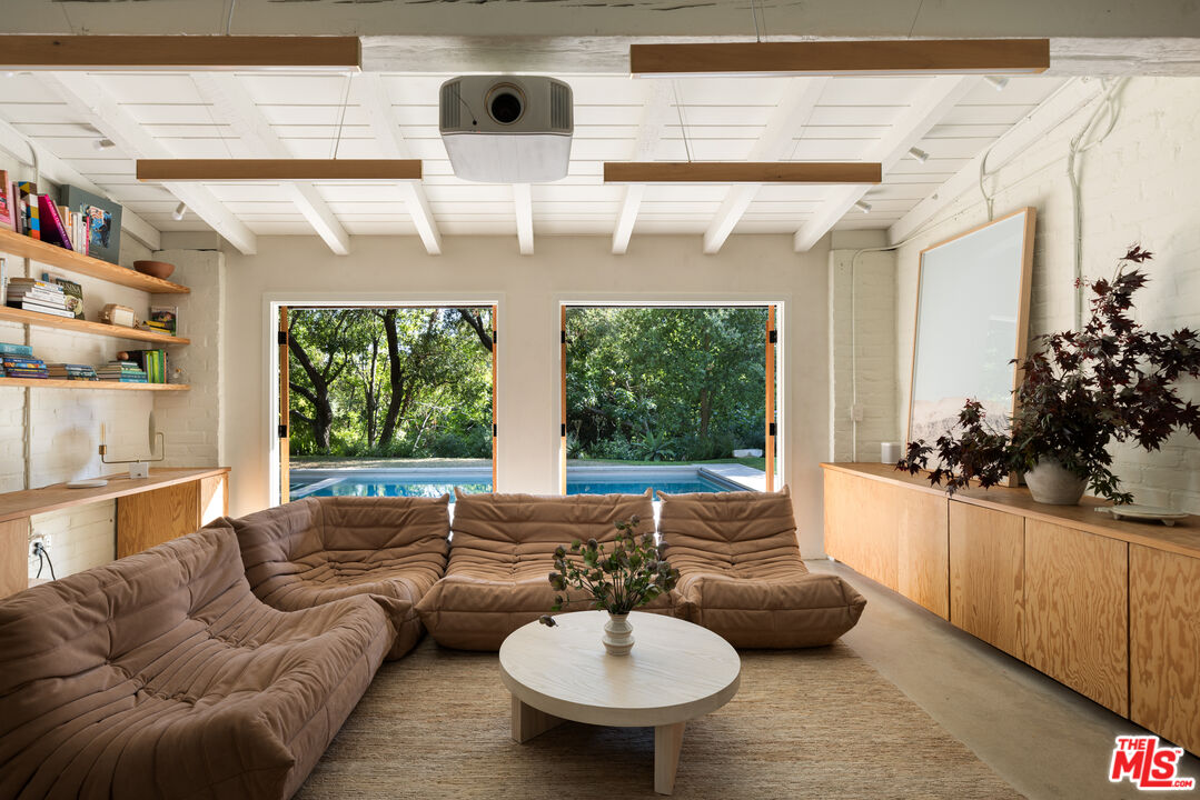 1830 Old Orchard Road Los Angeles, CA 90049 - Photo 13 of 30 a living room with furniture and a chandelier