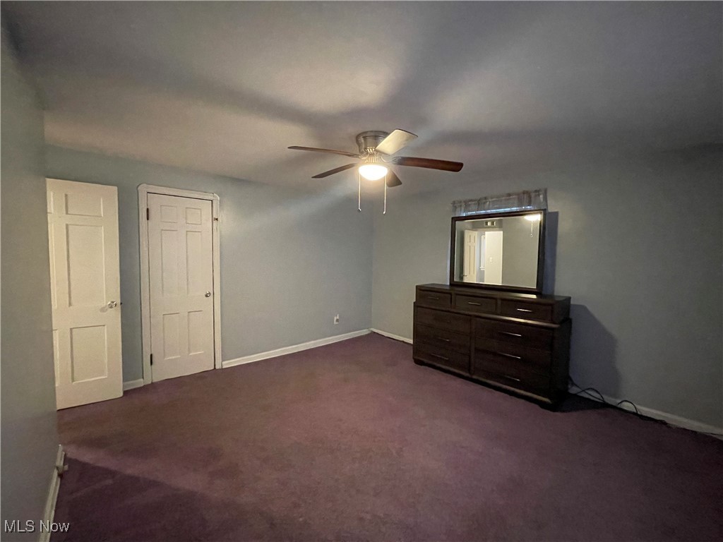 4241 Bluestone Road Cleveland, OH 44121 - Photo 20 of 31 Unfurnished bedroom with dark carpet and ceiling fan