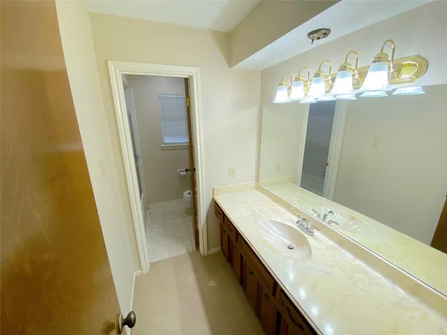a large bathroom with a large tub and sink