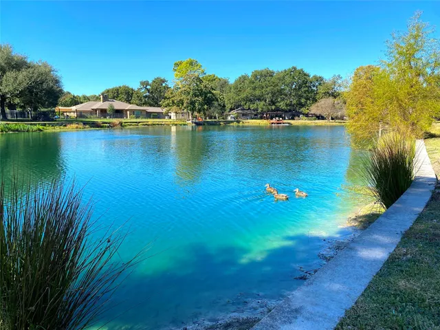 a view of a lake with a house in the background