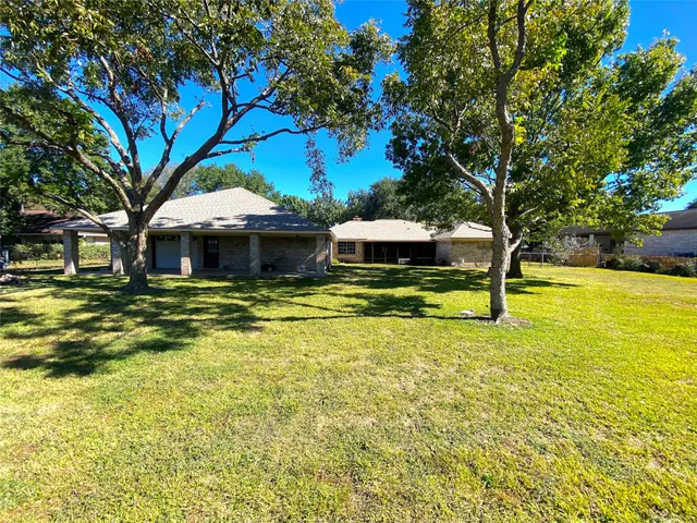 a view of a house with swimming pool and sitting area