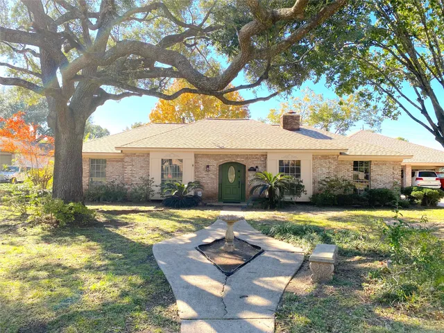 a front view of a house with trees