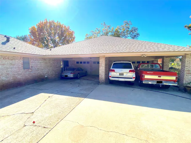 a large kitchen with a stove a refrigerator a sink dishwasher with a dining table and chairs