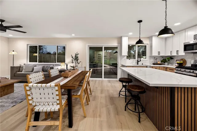 a kitchen with kitchen island a sink counter and chairs