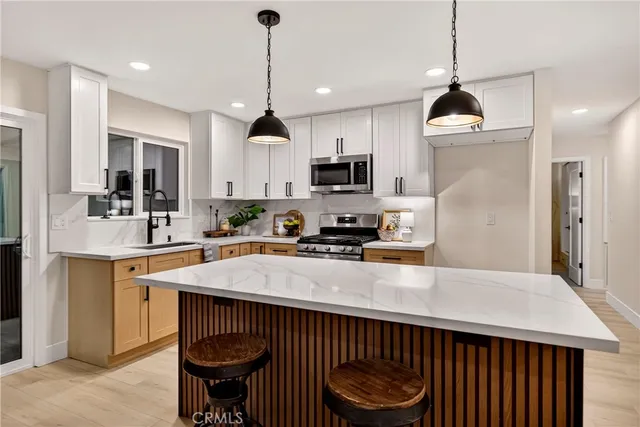 a kitchen with a stove a sink and a refrigerator