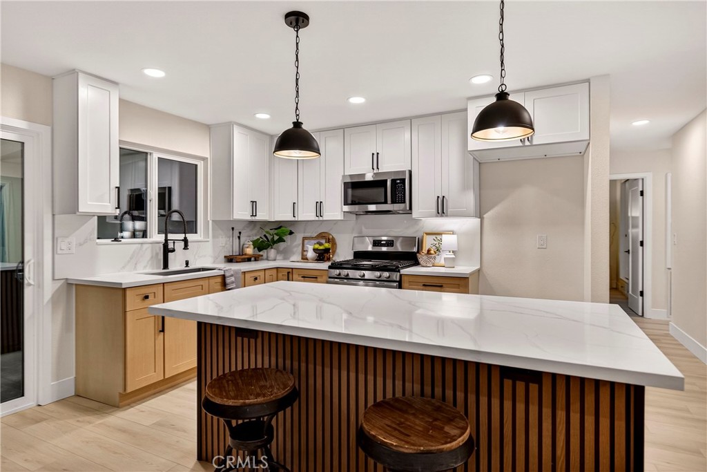 1623 Diamond Chico, CA 95928 - Photo 12 of 51 a kitchen with kitchen island a sink counter and chairs