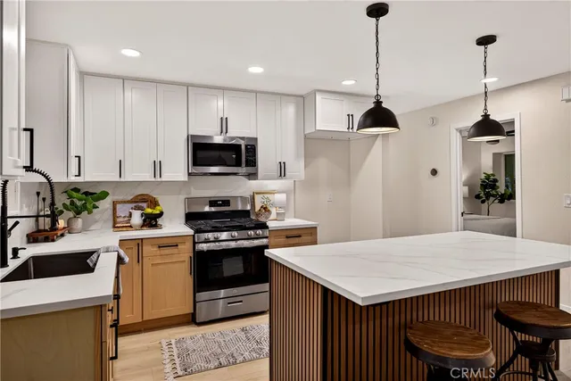 a kitchen with a sink and a stove top oven