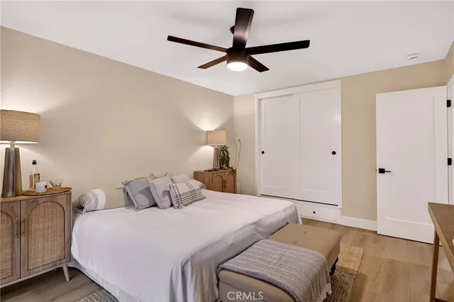 a bedroom with a bed and a potted plant