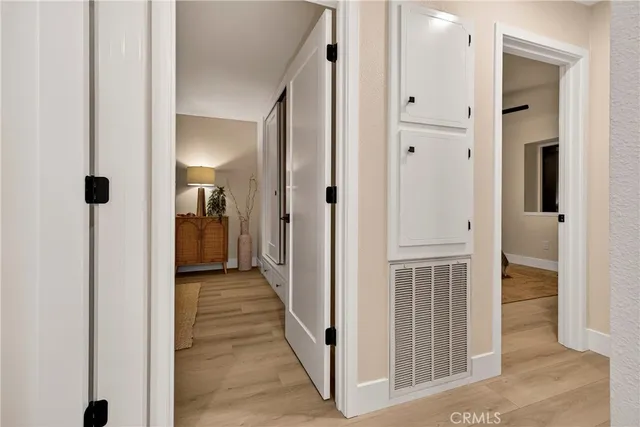 a bedroom with a bed and a large mirror with a chandelier