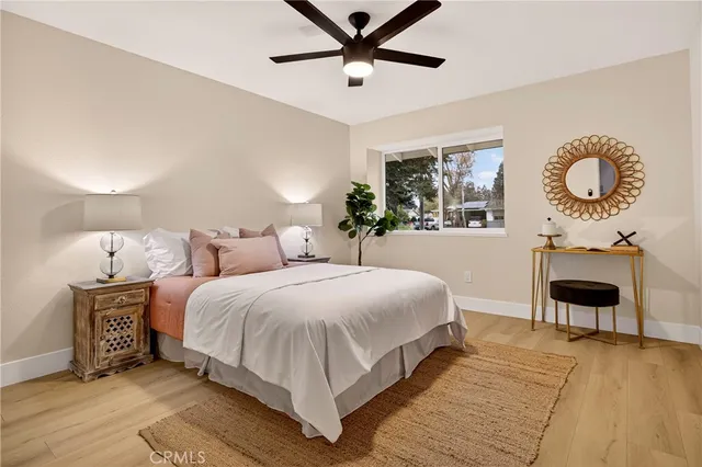 a bedroom with a large bed and a chandelier