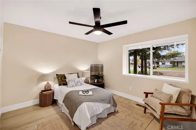 a bedroom with a bed and wooden floor