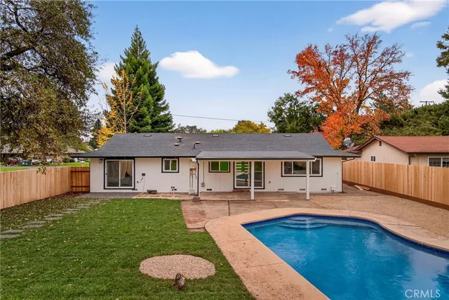 an aerial view of a house with a garden and swimming pool
