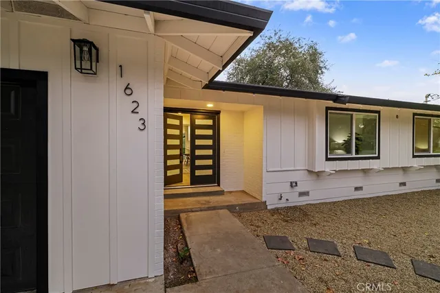 a view of a hallway and a livingroom with workspace