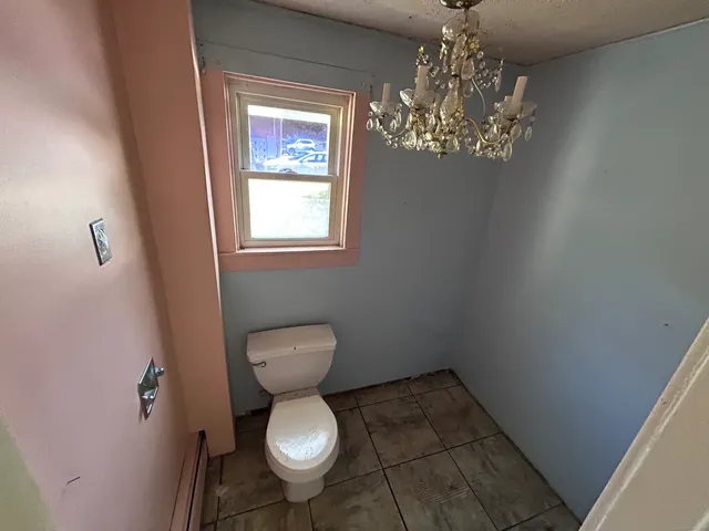 a bathroom with a toilet and a shower curtain